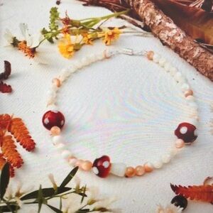 Elegant Beaded Necklace with Red and Cream Accents